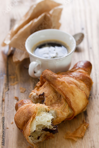 croissant with chocolate and cup of coffee