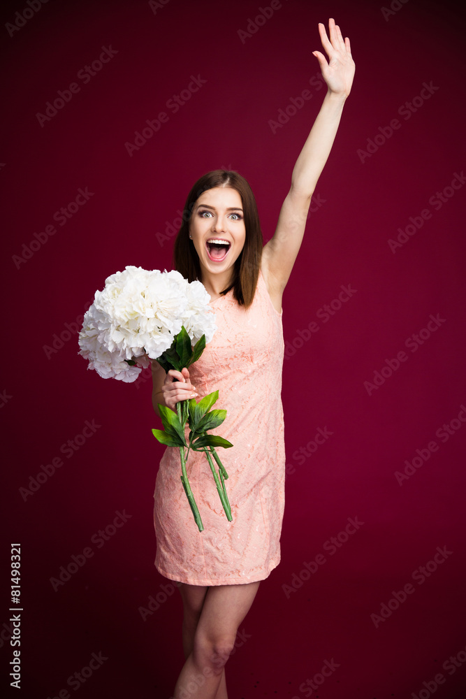 Cheerful beautiful woman holding flowers