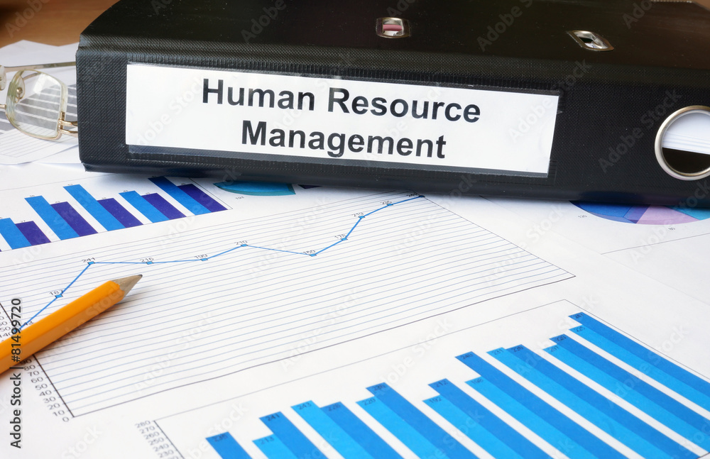 Graphs and file folder with label Human Resource Management. Graphs and file folder with label Human Resource Management.