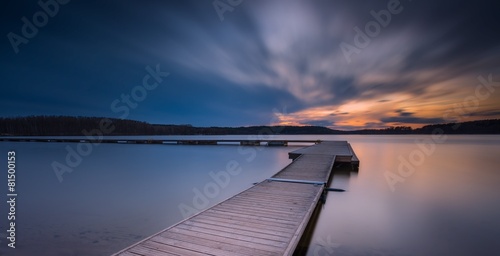 Fotografie Beautiful long exposure lake with jetty at sunset.
