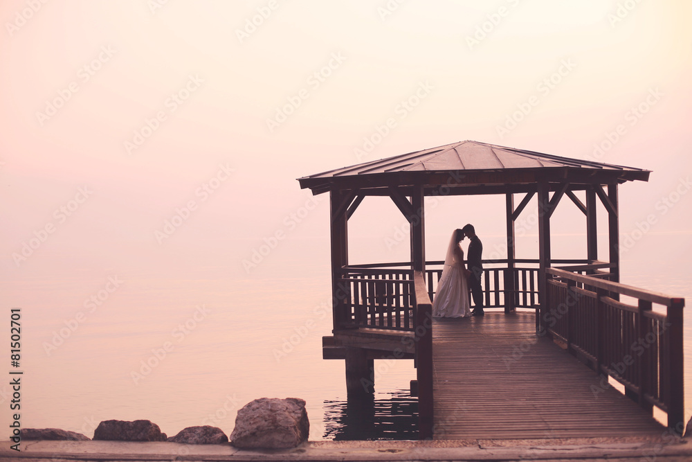 Bride and groom on pier