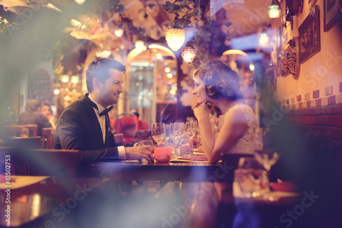 Bride and groom sitting on table
