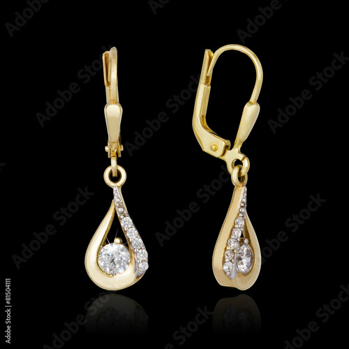 Gold earrings isolated on the black background