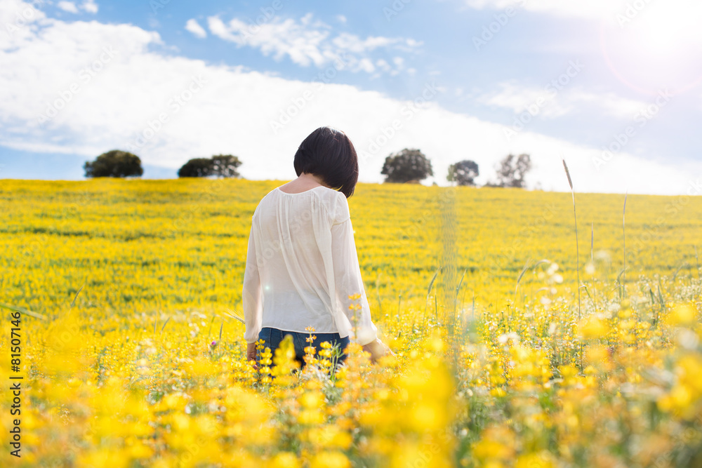 Woman in yellow field