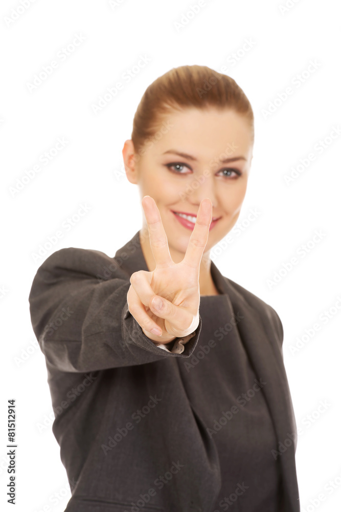 Business woman showing victory sign. Business woman showing victory sign.