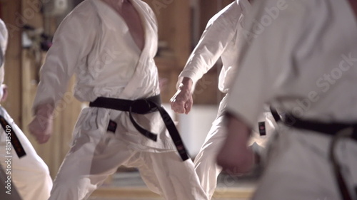 group of people practicing karate kata photo