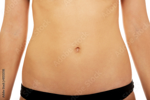 Fit and slim young woman belly.