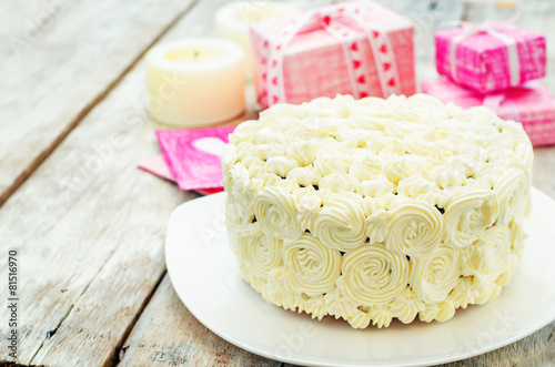 cake with vanilla cream in the form of roses