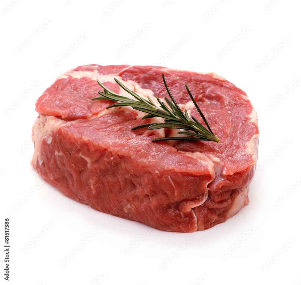 Raw ribeye steak garnished with sprig of rosemary