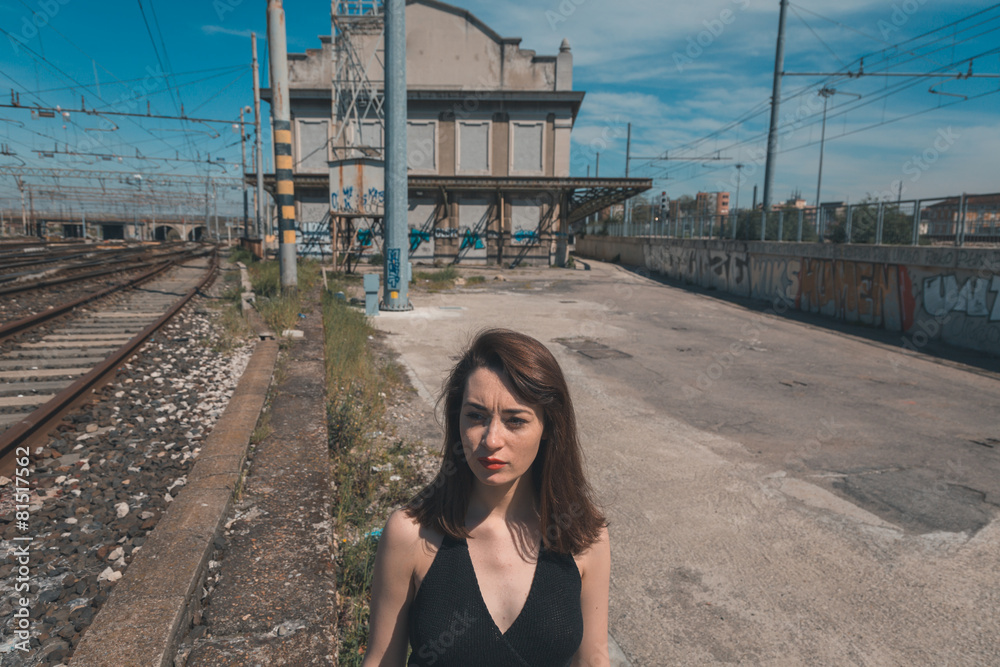 Beautiful brunette posing in an industrial context