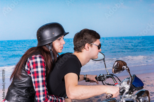 Young Couple Riding Motorcycle on Beach