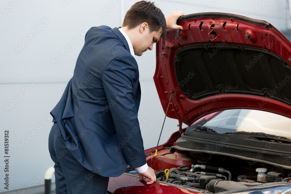 car sales manager looking under the bonnet of automobile car sales manager looking under the bonnet of automobile