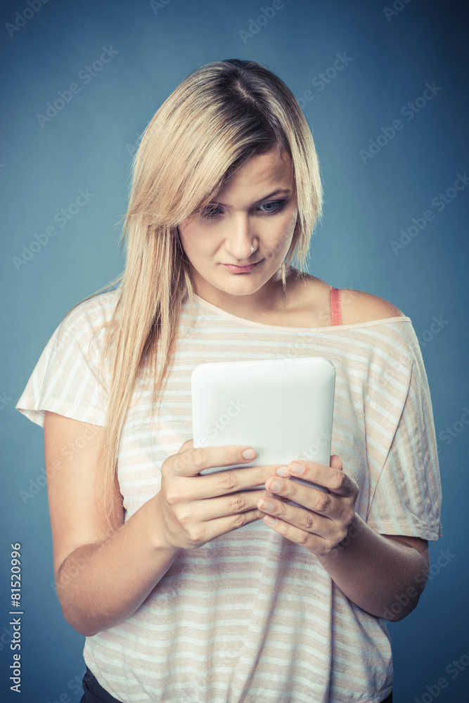 Young woman with tablet on blue Young woman with tablet on blue