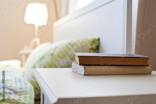 bedroom with books on nightstand photo