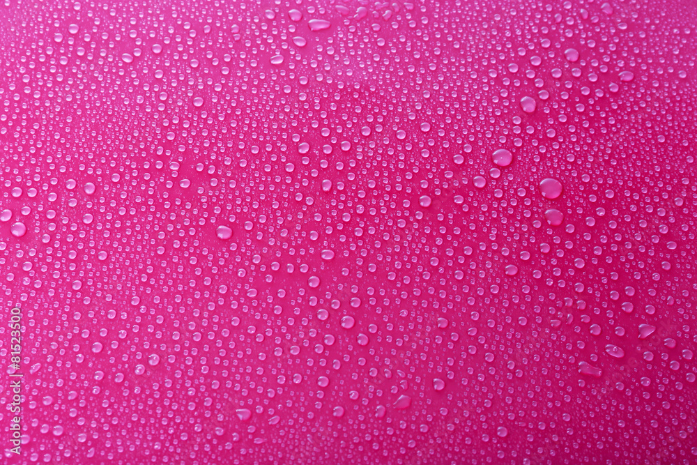 Water drops on glass on pink background Water drops on glass on pink background