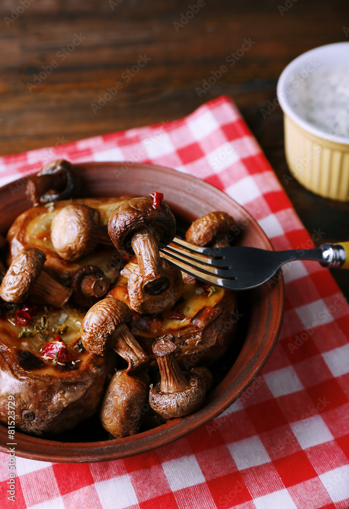 Fototapeta premium Baked potatoes with mushrooms in bowl and sauce