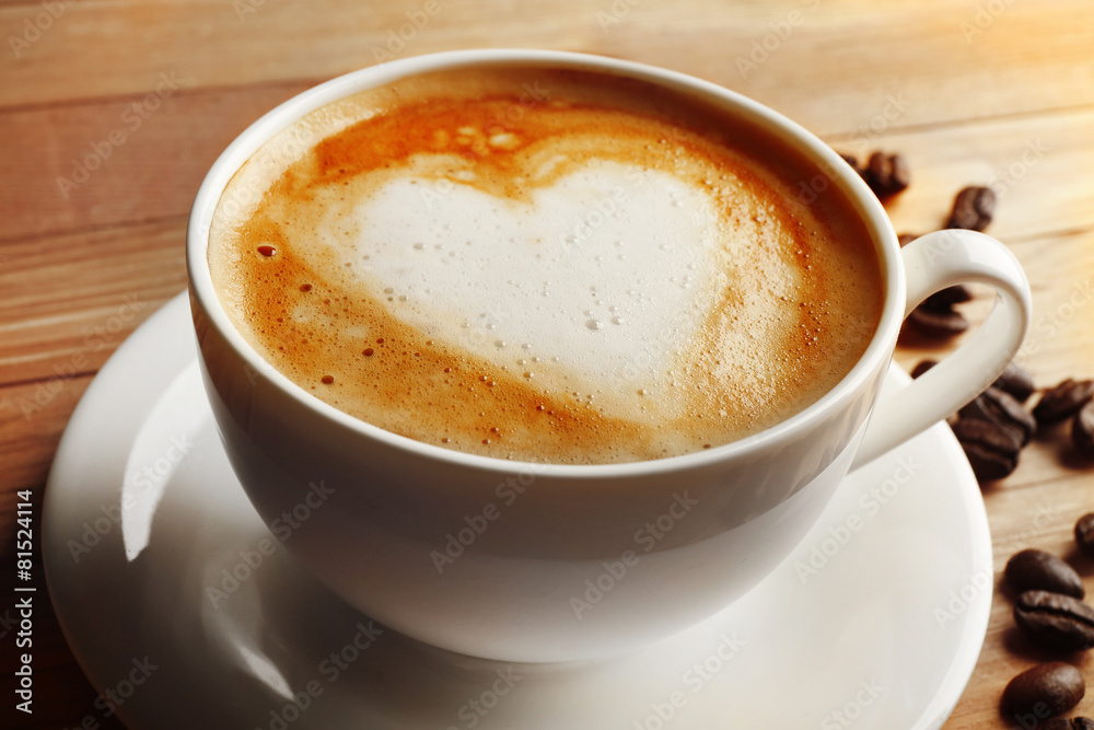 Cup of coffee latte art with grains on wooden table, closeup Cup of coffee latte art with grains on wooden table, closeup