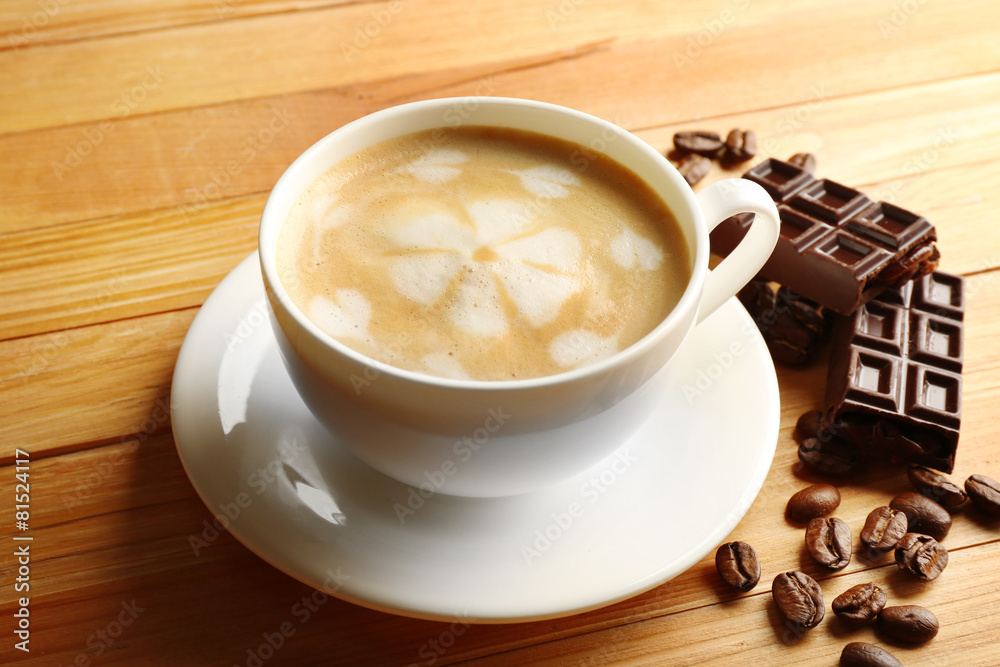 Cup of coffee latte art with grains and chocolate bar Cup of coffee latte art with grains and chocolate bar