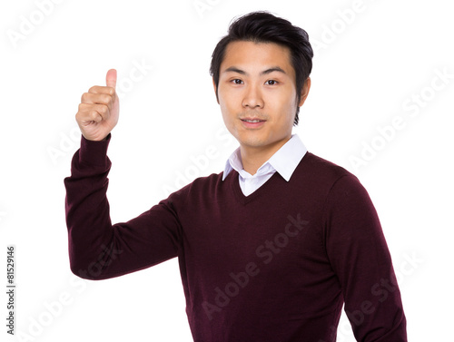 Showing thumb young Asian business man © leungchopan