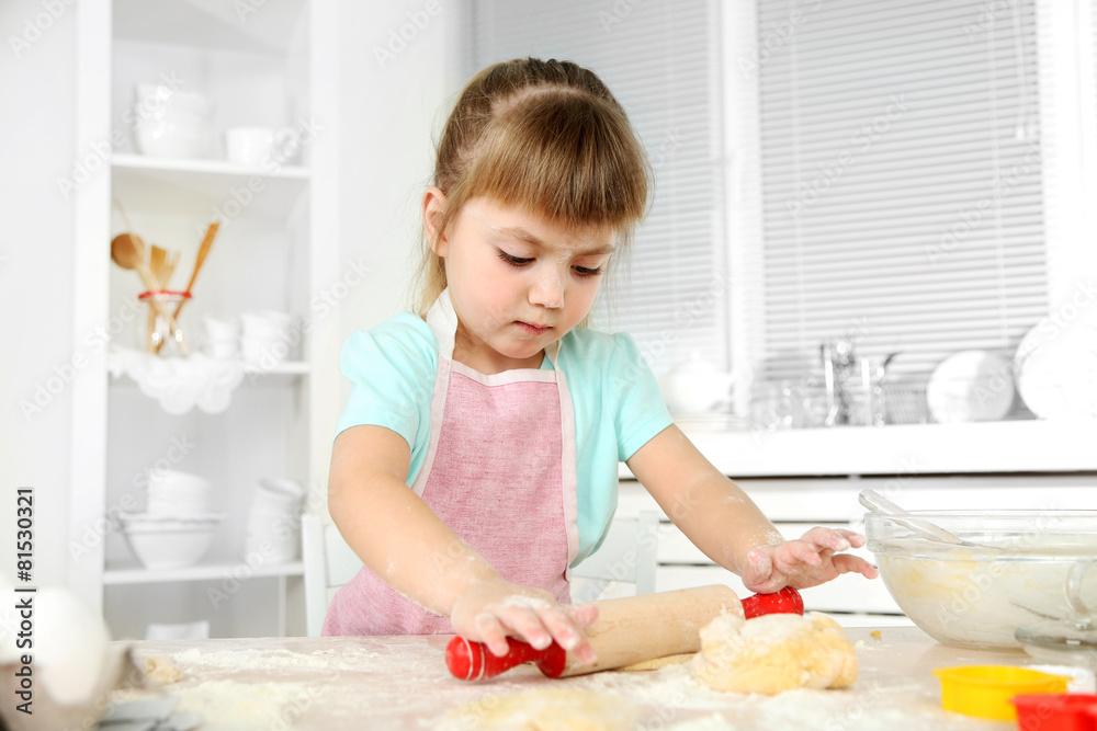 Little girl preparing cookies in kitchen at home Little girl preparing cookies in kitchen at home