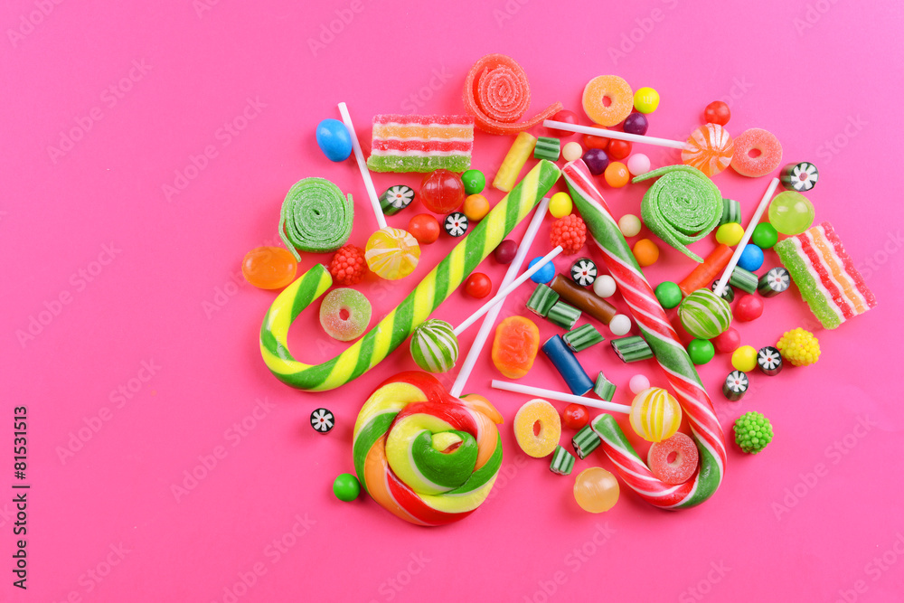 Fototapeta premium Colorful candies on pink background