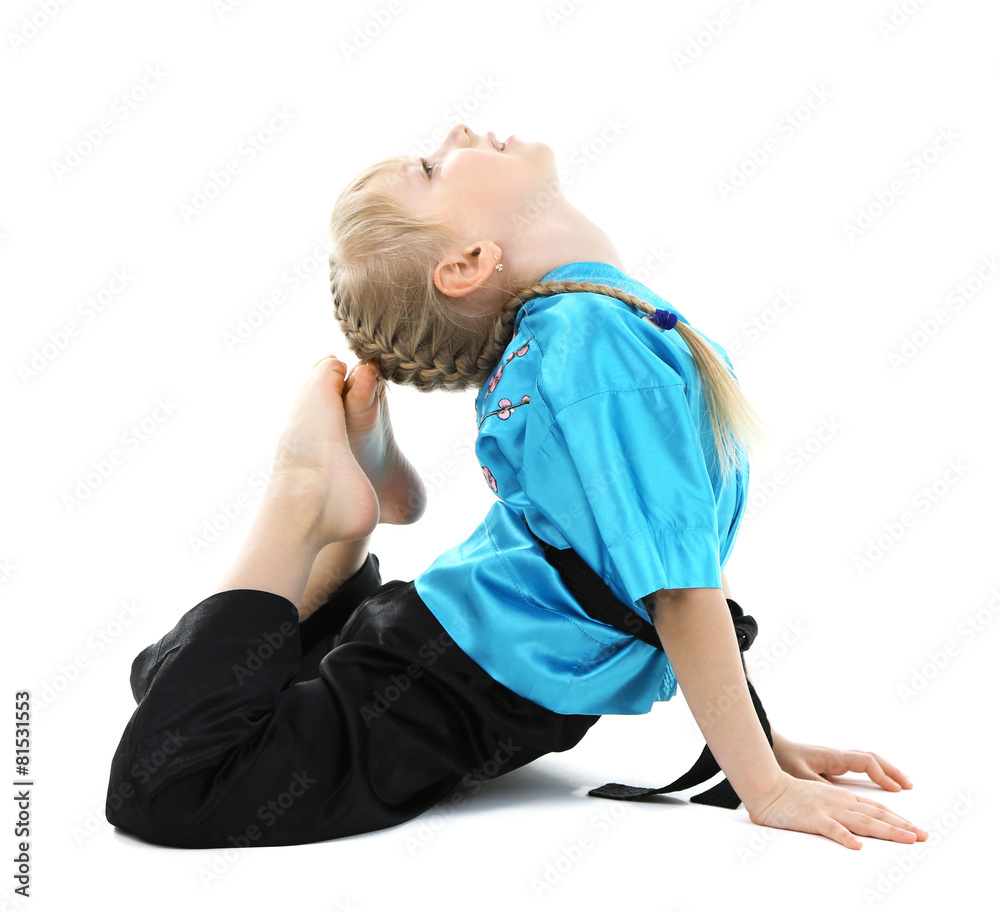 Little girl in kimono doing exercises isolated on white Little girl in kimono doing exercises isolated on white