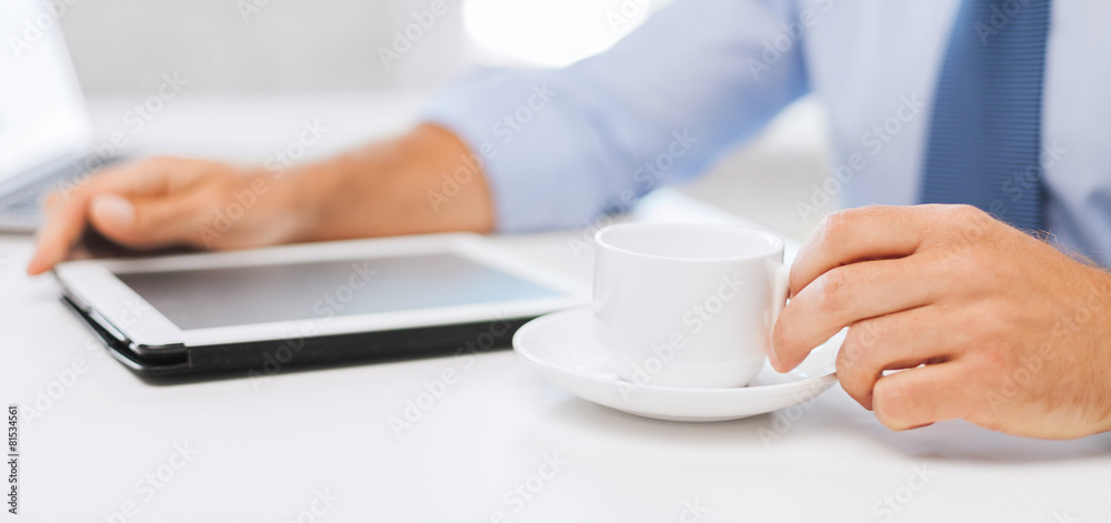 businessman with tablet pc and coffee in office businessman with tablet pc and coffee in office