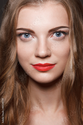 Beautiful caucasian young woman with red lips make up