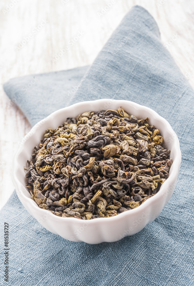Dried green leaves of tea in a bowl Dried green leaves of tea in a bowl