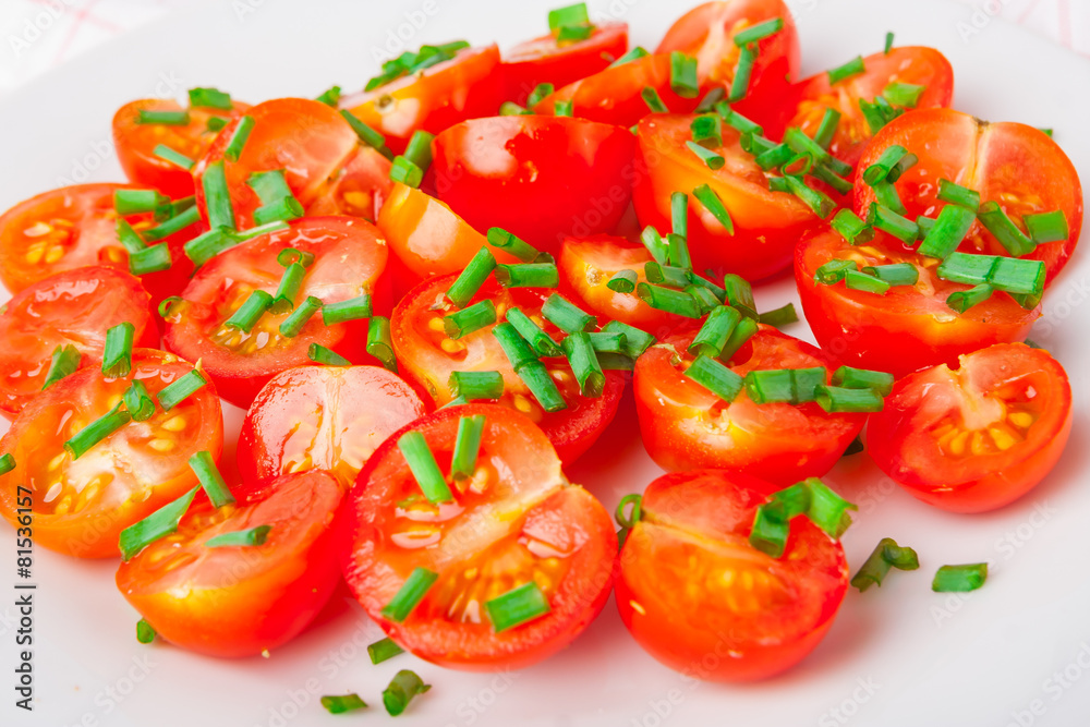 tomatoes with chives on white plate tomatoes with chives on white plate