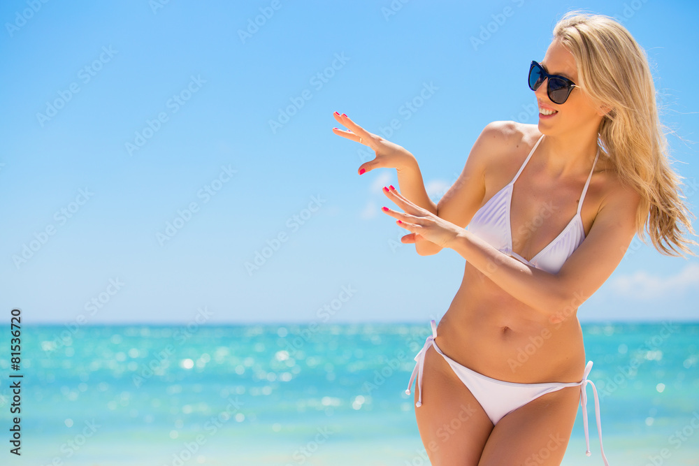 Cheerful woman in white bikini on the beach Cheerful woman in white bikini on the beach