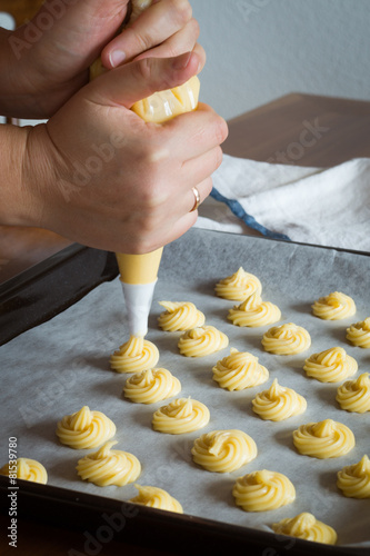 Piping Choux Paste for Cream Puffs onto Parchment-lined Pan