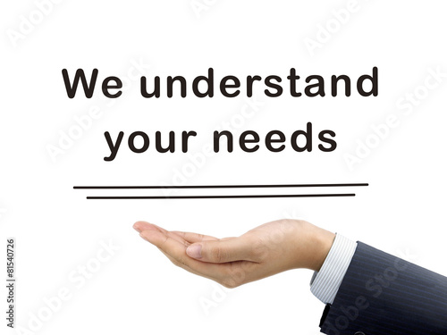 Photo we understand your needs holding by businessman's hand