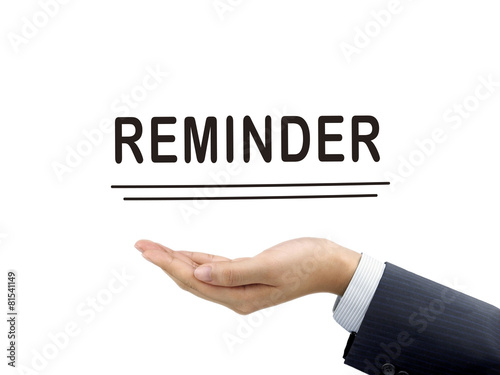 reminder word holding by businessman's hand
