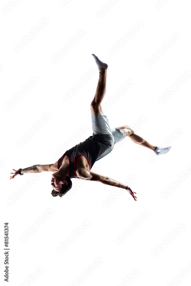 Isolated white young man is jumping on trampoline Isolated white young man is jumping on trampoline