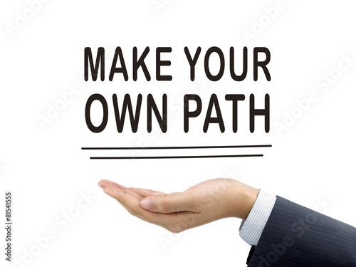 make your own path words holding by businessman's hand