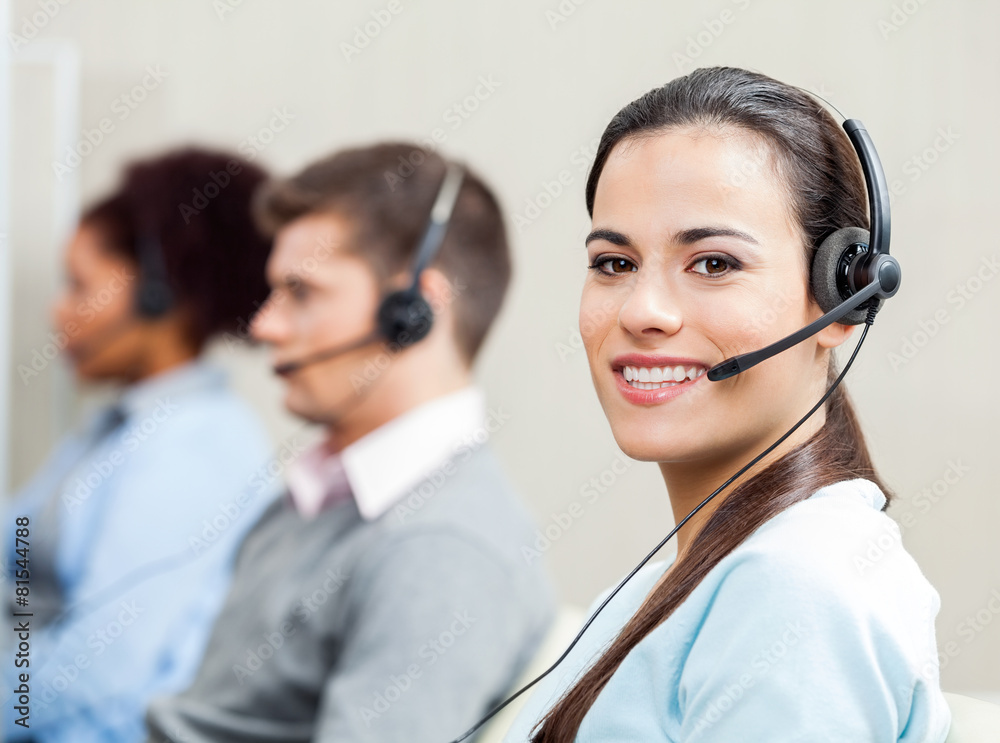 Smiling Female Customer Service Representative In Office Smiling Female Customer Service Representative In Office