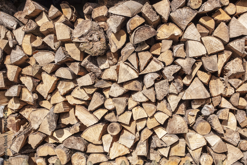 firewood stacked in a woodpile in the yard firewood stacked in a woodpile in the yard