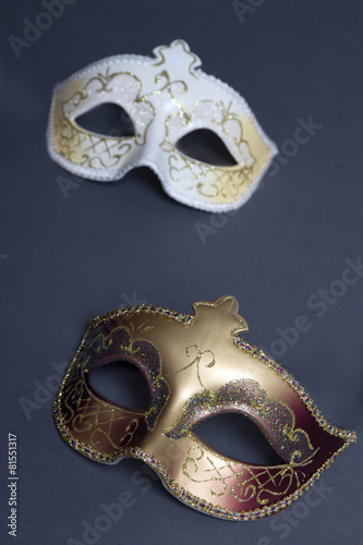 close up of two beautiful carnival masks on grey