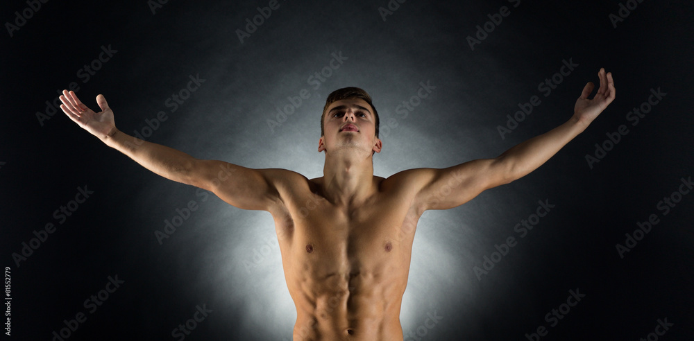 Obraz premium young male bodybuilder with raised hands