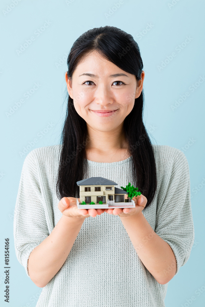 asian businesswoman with miniature house asian businesswoman with miniature house
