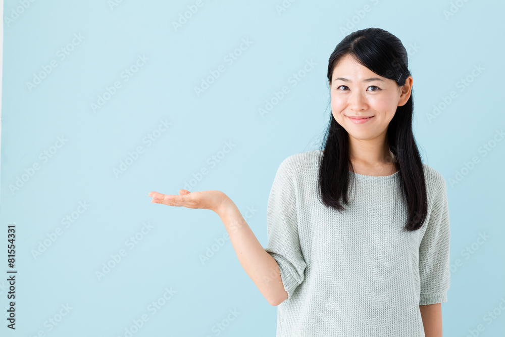 young asian woman showing on blue background young asian woman showing on blue background