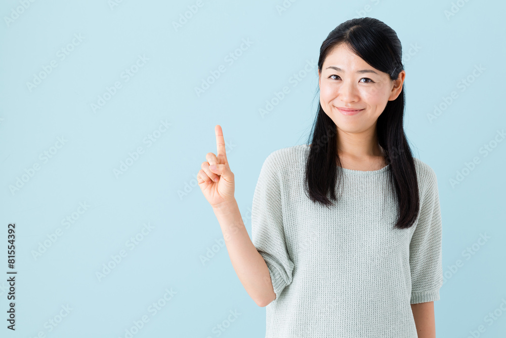 young asian woman showing on blue background young asian woman showing on blue background