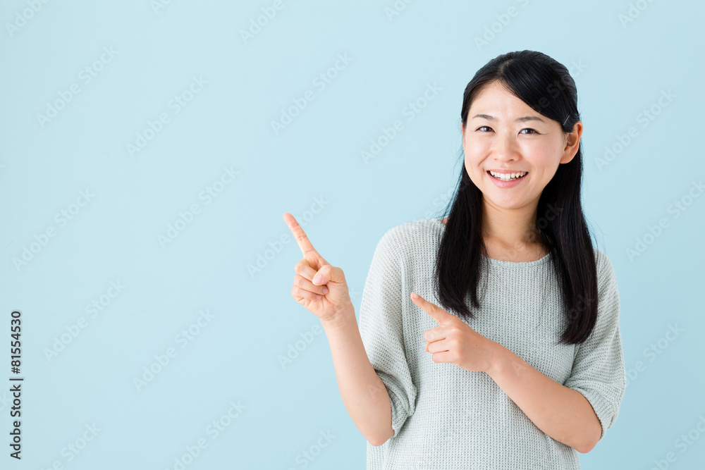 young asian woman showing on blue background young asian woman showing on blue background