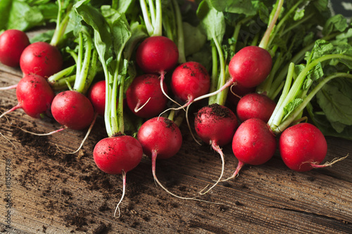 Fotótapéta Bunch of healthy ripe radishes on rustic wooden background