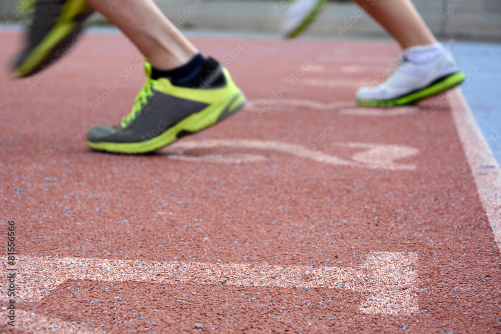 Two men running on running track