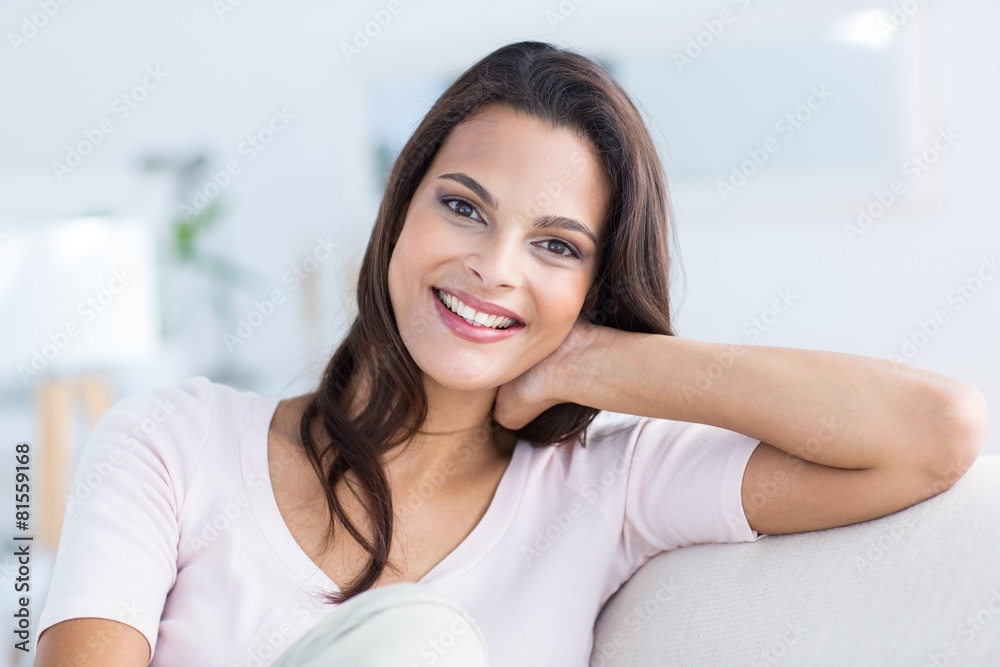 brunette relaxing on the couch and looking at camera brunette relaxing on the couch and looking at camera
