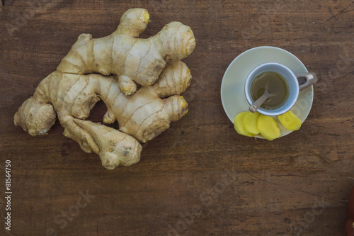 Ginger root and ginger tea on a wooden table