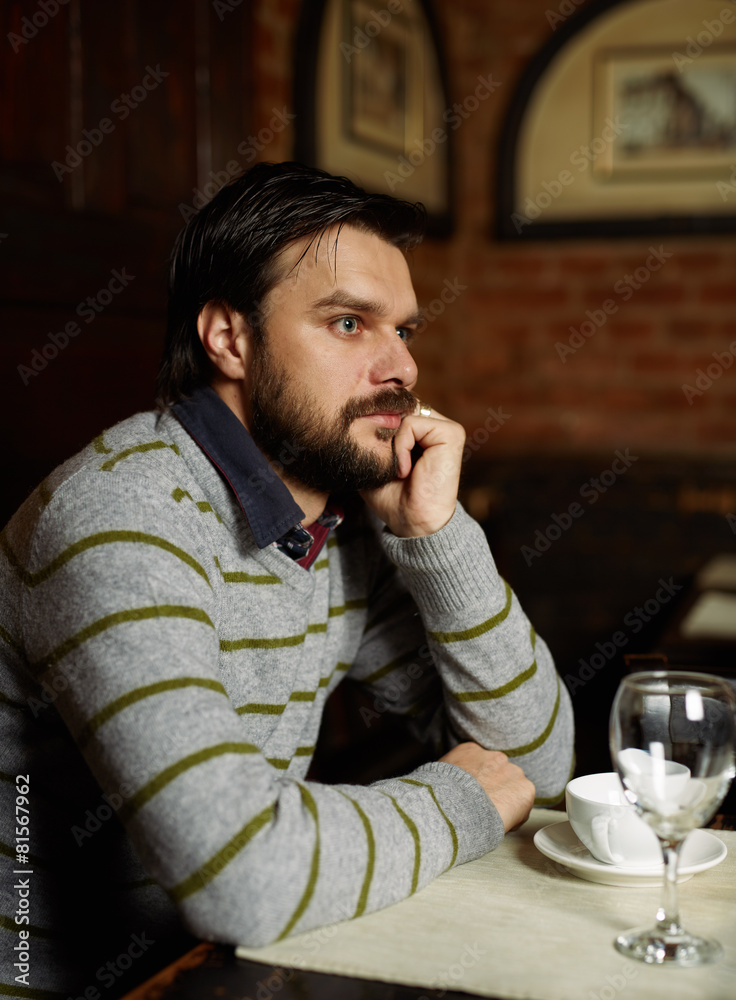 Young man drinking coffee in a restaurant