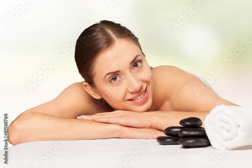 Spa. Relaxed young female getting a stone massage in a spa